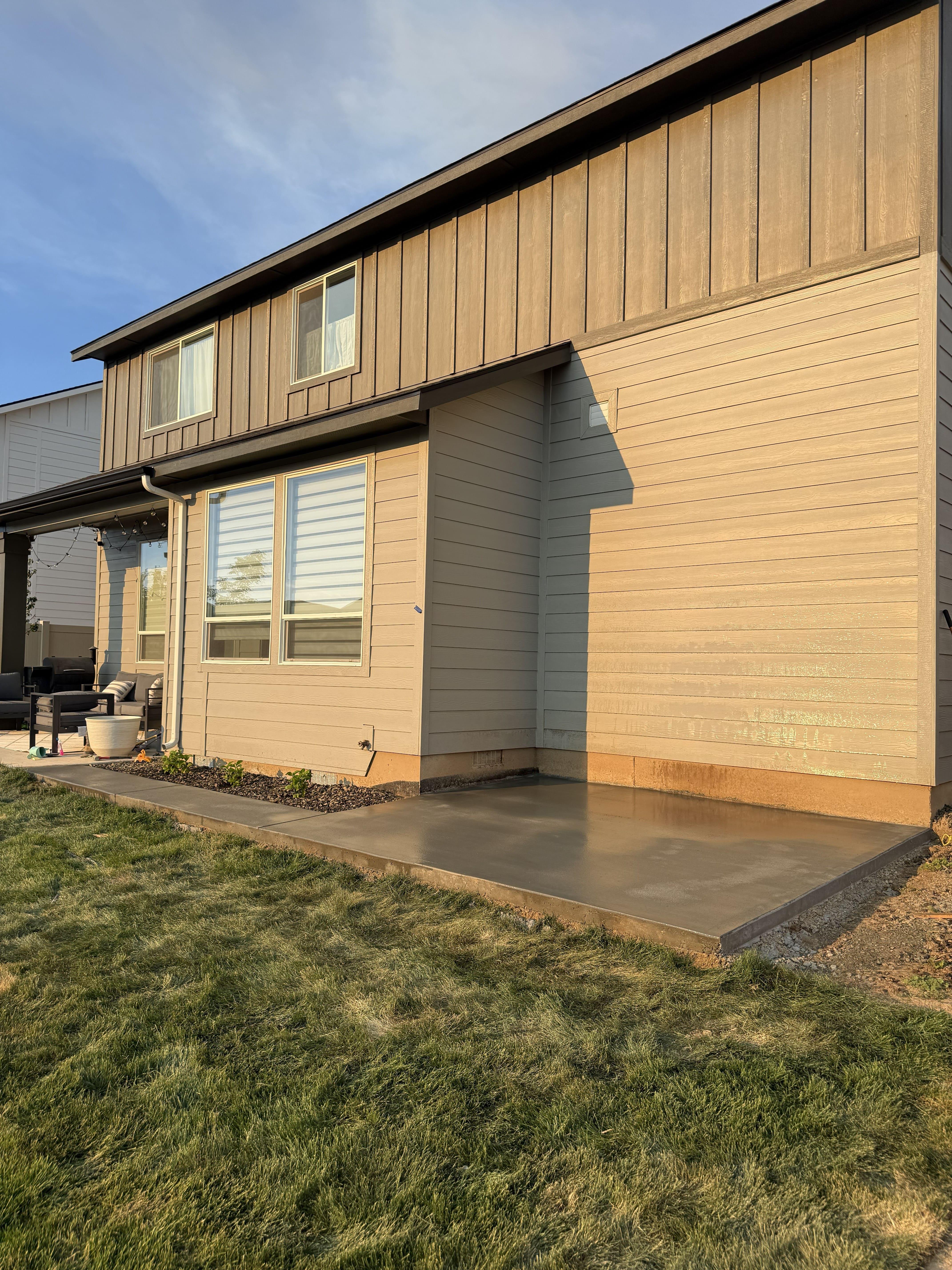 Completed backyard concrete patio with a smooth finished surface