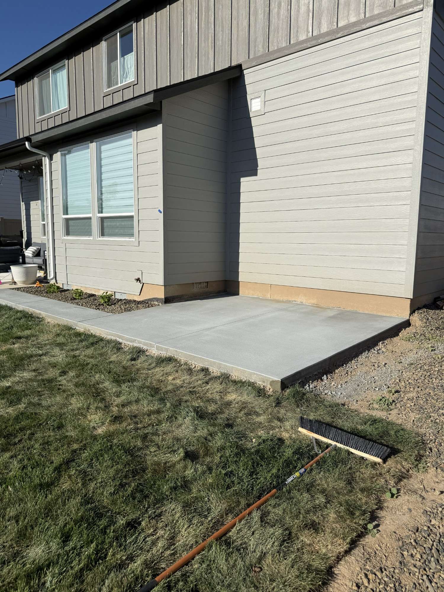 Finished concrete pad tied cleanly into an existing home